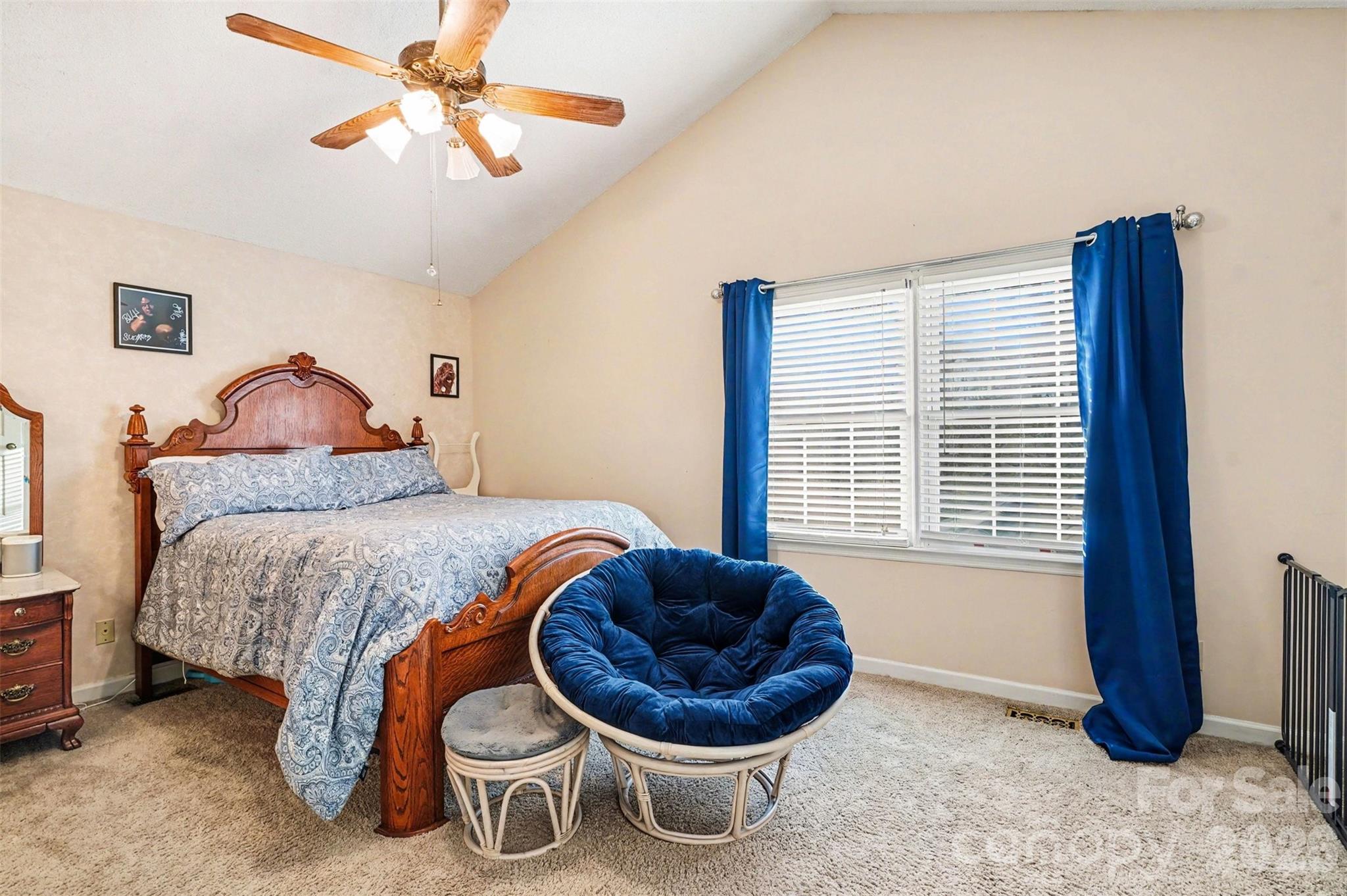 313 Wisteria Lane Kannapolis, NC 28083 - Photo 14 of 23 a bedroom with a bed and a chandelier