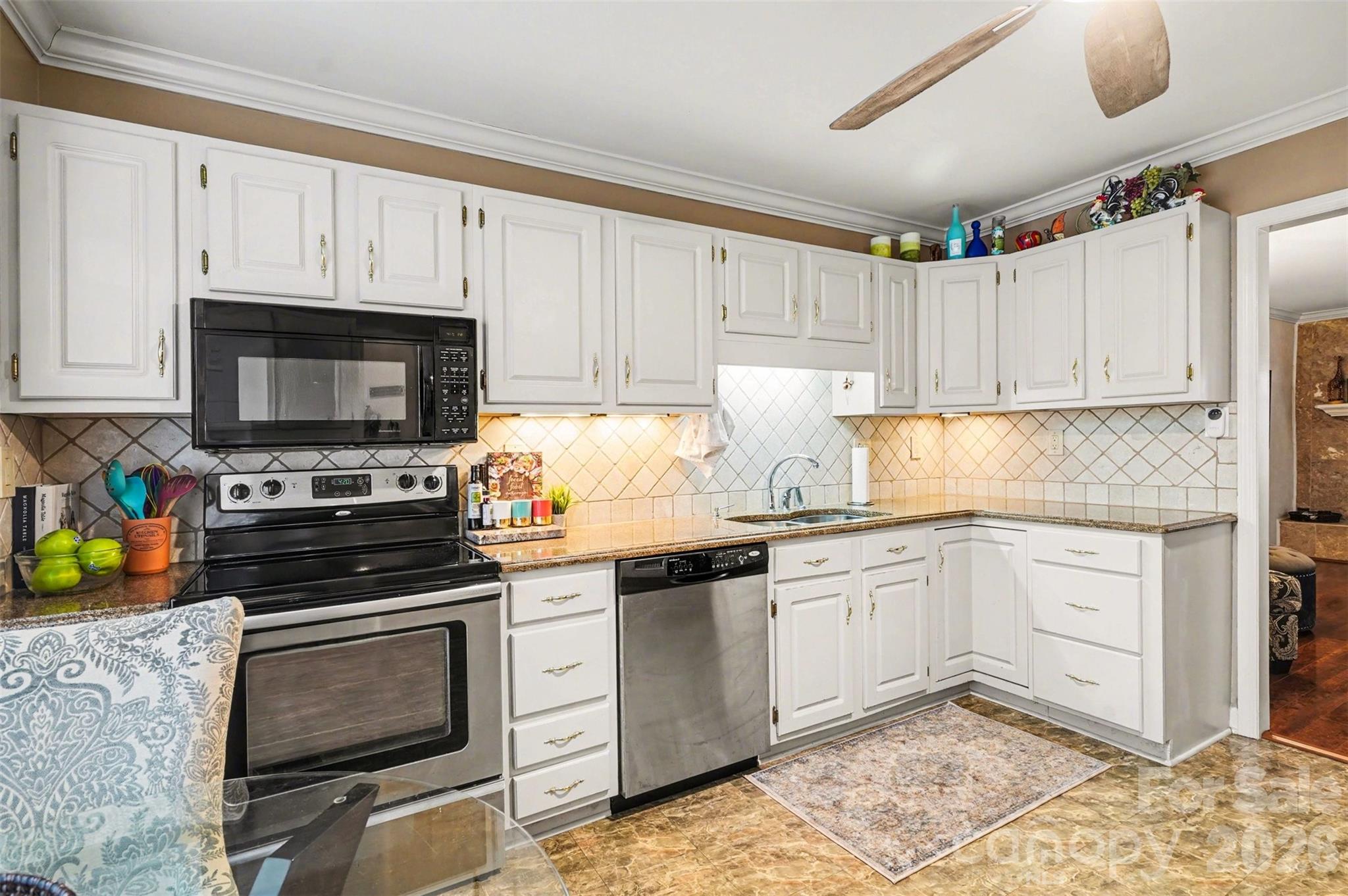 313 Wisteria Lane Kannapolis, NC 28083 - Photo 6 of 23 a kitchen with granite countertop a stove sink and cabinets