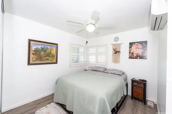 a spacious bedroom with a bed and a chandelier