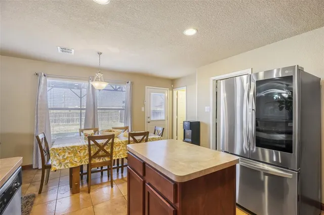 a view of a kitchen with dining table and chairs