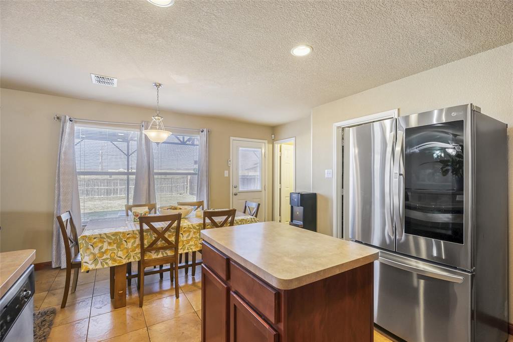 2002 Pin Oak Trail Anna, TX 75409 - Photo 13 of 29 a view of a kitchen with dining table and chairs