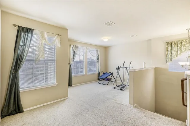 a view of a livingroom with furniture and a window