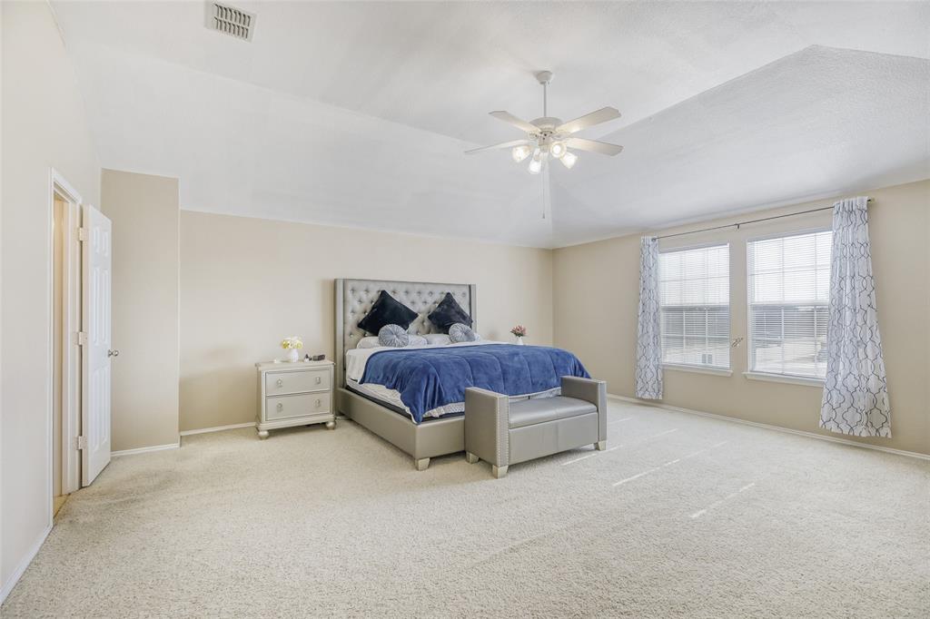 2002 Pin Oak Trail Anna, TX 75409 - Photo 17 of 29 a spacious bedroom with a bed and a large window