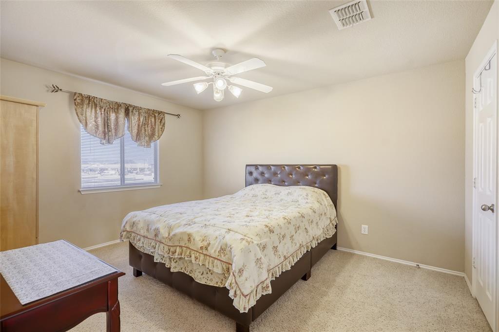 2002 Pin Oak Trail Anna, TX 75409 - Photo 22 of 29 a bedroom with a bed and a chandelier
