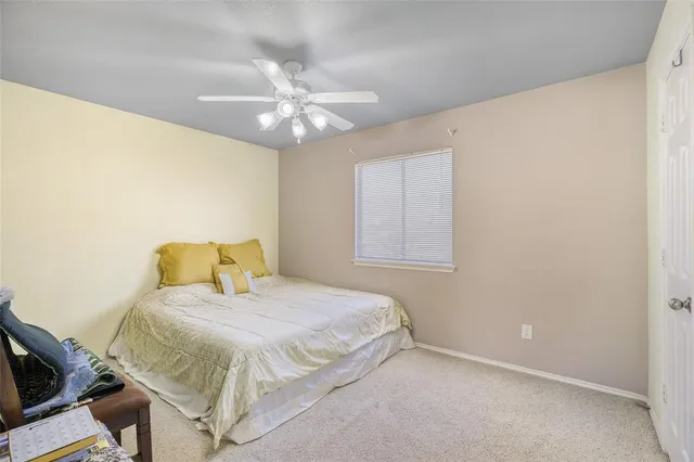 a bedroom with a bed chandelier and a window