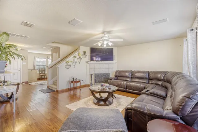 a living room with furniture and wooden floor