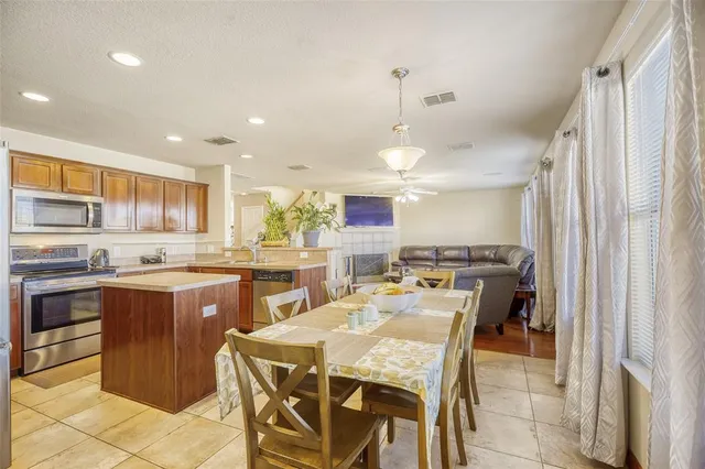 a large kitchen with a table and chairs in it