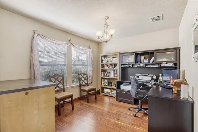 a view of a livingroom with workspace and a window