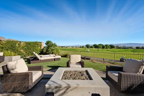 a view of a patio with couches chairs and a yard
