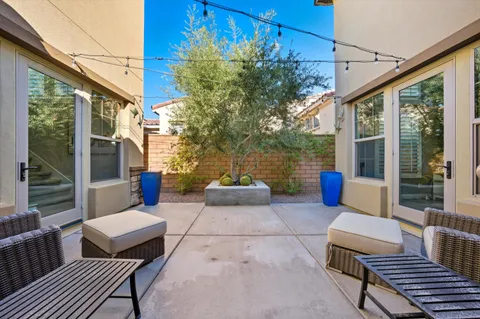 a backyard of a house with table and chairs