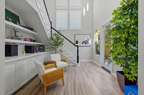 a living room with furniture and a potted plant