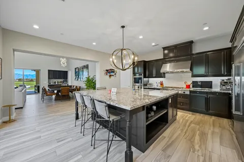 a kitchen with granite countertop counter space a sink appliances and a wooden floor