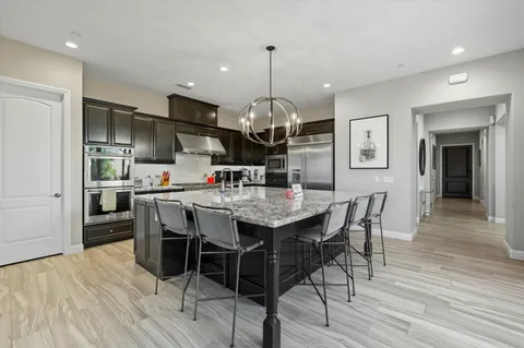 a view of a dining room with furniture wooden floor and chandelier