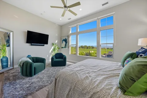 a bedroom with a bed and a flat screen tv