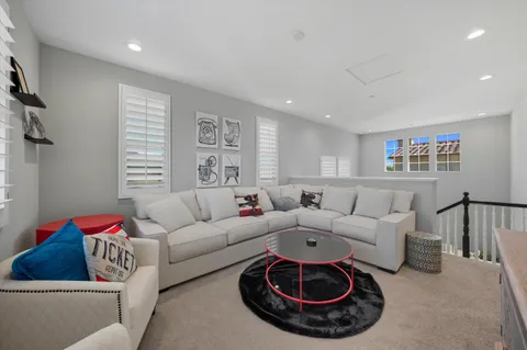 a living room with furniture and a rug