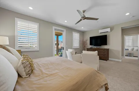 a bedroom with a large bed and a flat screen tv