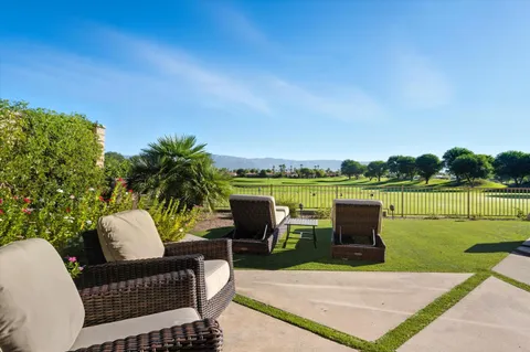 a view of a patio with swimming pool and a yard