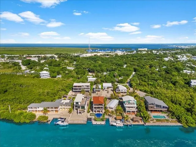an aerial view of multiple houses with outdoor space
