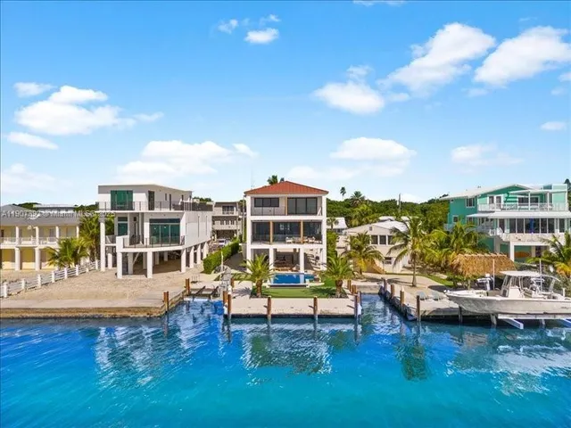 a bedroom with a bed a dresser and a window