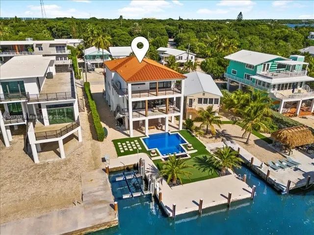 an aerial view of residential houses with outdoor space and street view