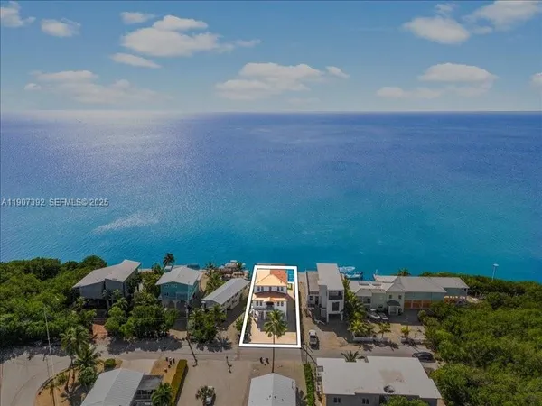 a view of a house with swimming pool and sitting area