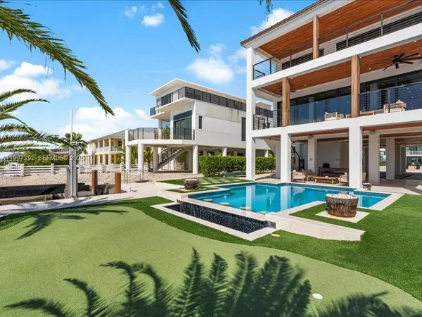 a view of a swimming pool with seating space and deck