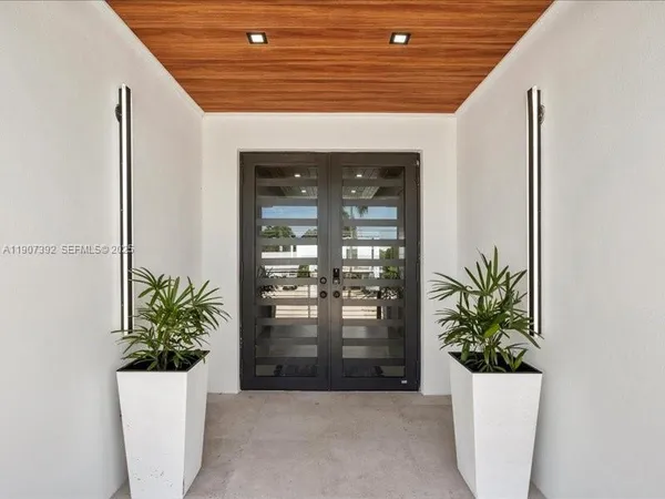 a room with wooden floor table and sofas