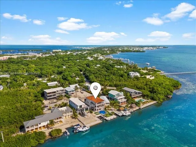 an aerial view of multiple houses with outdoor space
