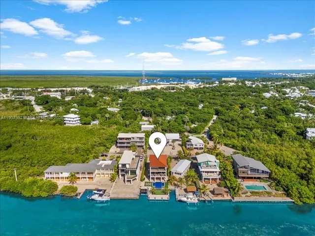 a view of a house with swimming pool and sitting area