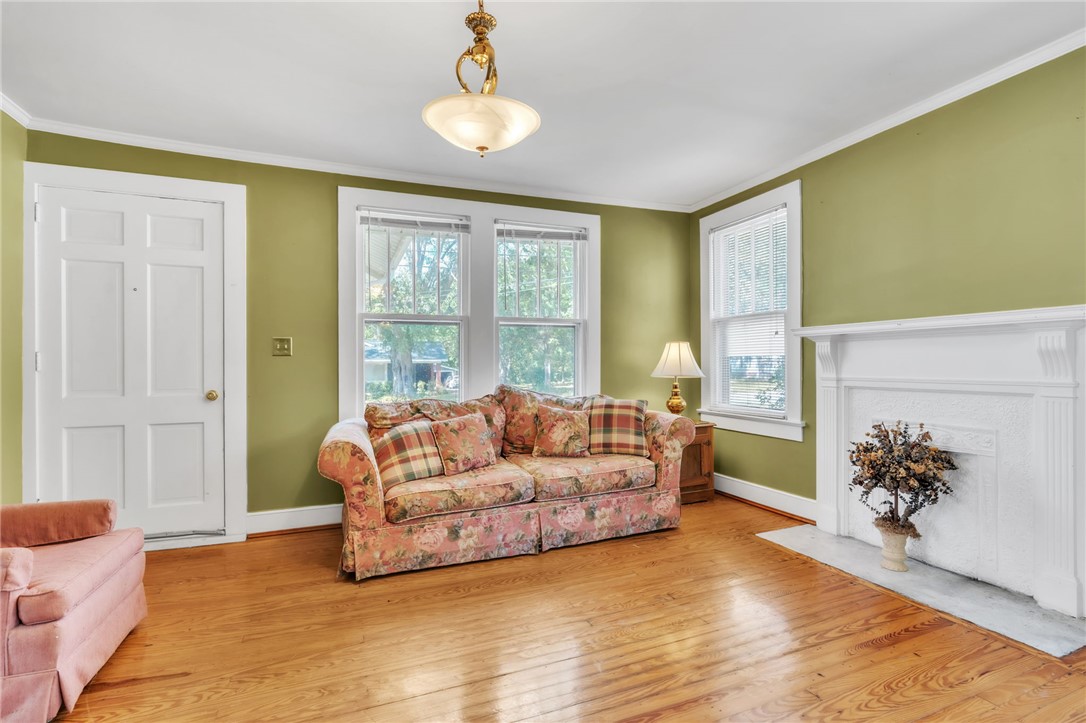 121 Ellison Street Belton, SC 29627 - Photo 3 of 30 This inviting living space features gleaming hardwood floors and a classic fireplace.