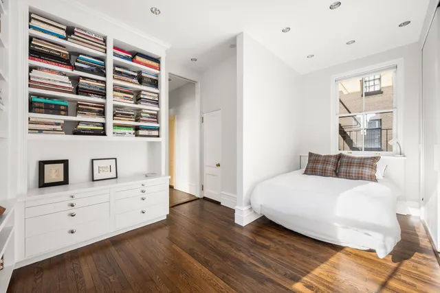 a spacious bedroom with a bed and a fireplace