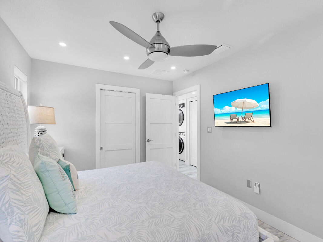 325 Calusa Street, Unit 359 Key Largo, FL 33037 - Photo 12 of 52 a bedroom with a large bed and a chandelier