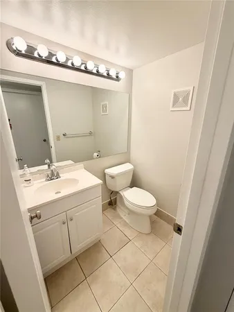 a bathroom with a toilet a sink and mirror