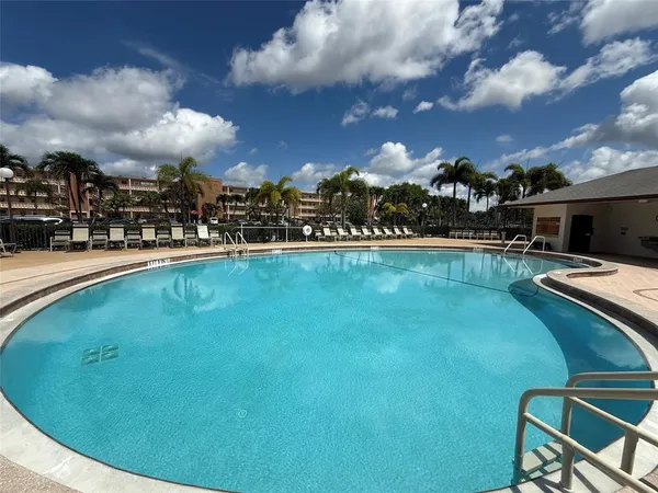 a view of a swimming pool with lawn chairs