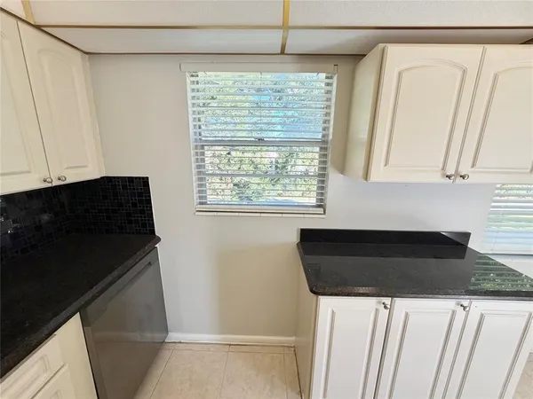 a view of a closet in an empty room and a window