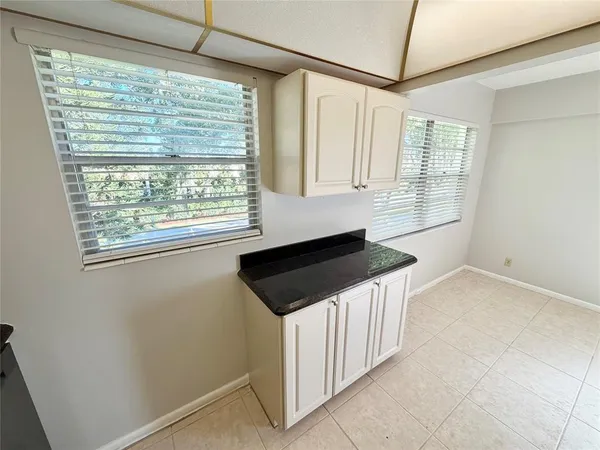a kitchen with granite countertop a sink and a stove