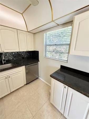 a view of a kitchen with a sink and dishwasher