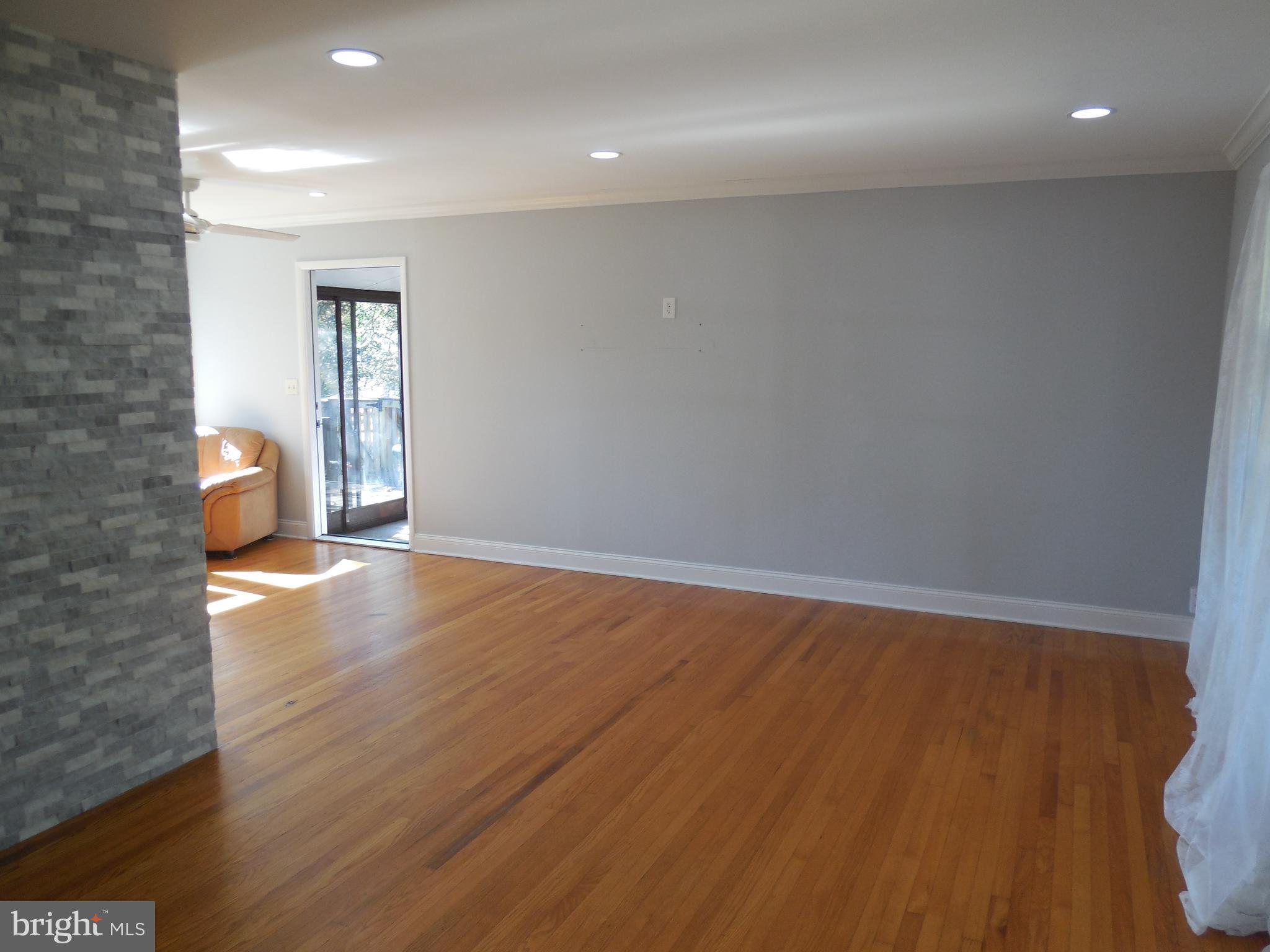 607 Church Road Reisterstown, MD 21136 - Photo 14 of 34 an empty room with wooden floor and windows