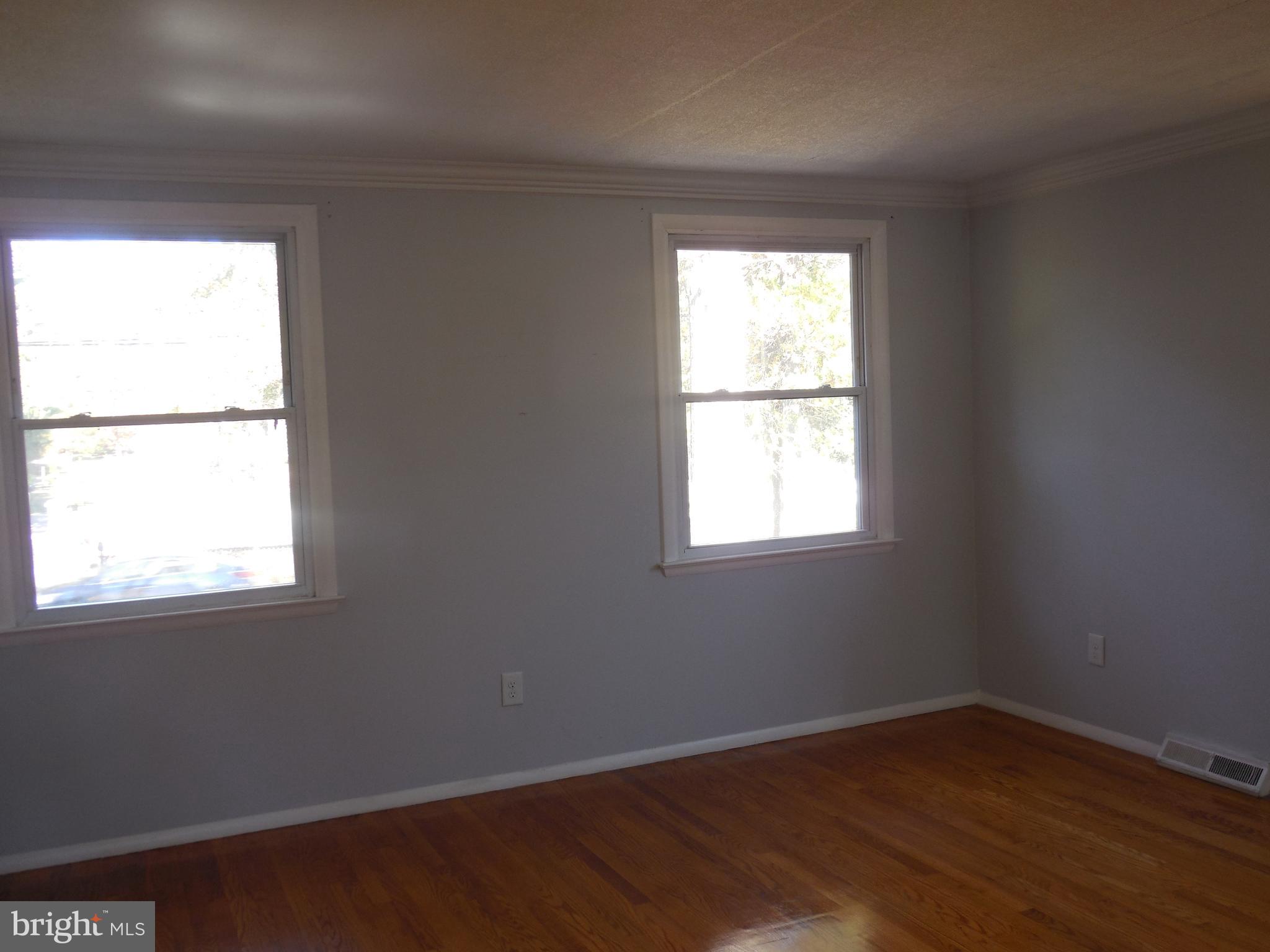 607 Church Road Reisterstown, MD 21136 - Photo 18 of 34 an empty room with wooden floor and windows
