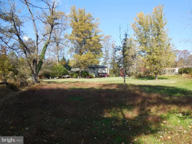 a view of a lake next to a yard