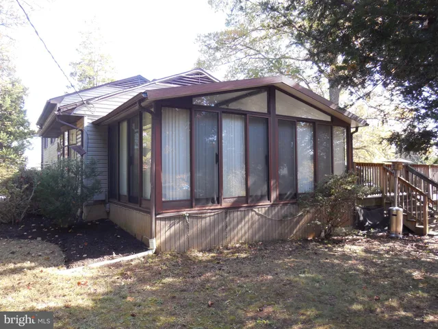 a view of a house with wooden fence