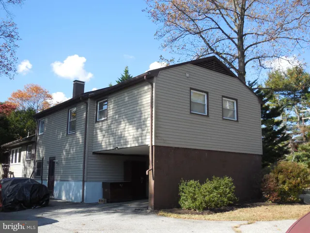 a front view of a house with a yard and potted plants