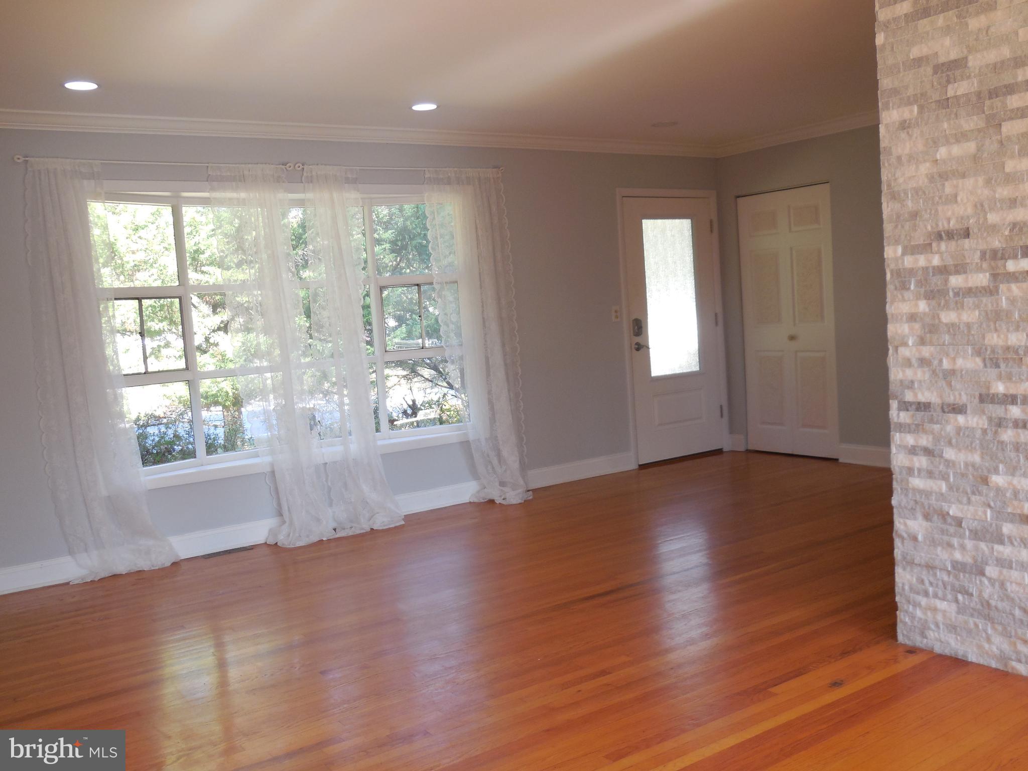 607 Church Road Reisterstown, MD 21136 - Photo 9 of 34 an empty room with wooden floor and windows