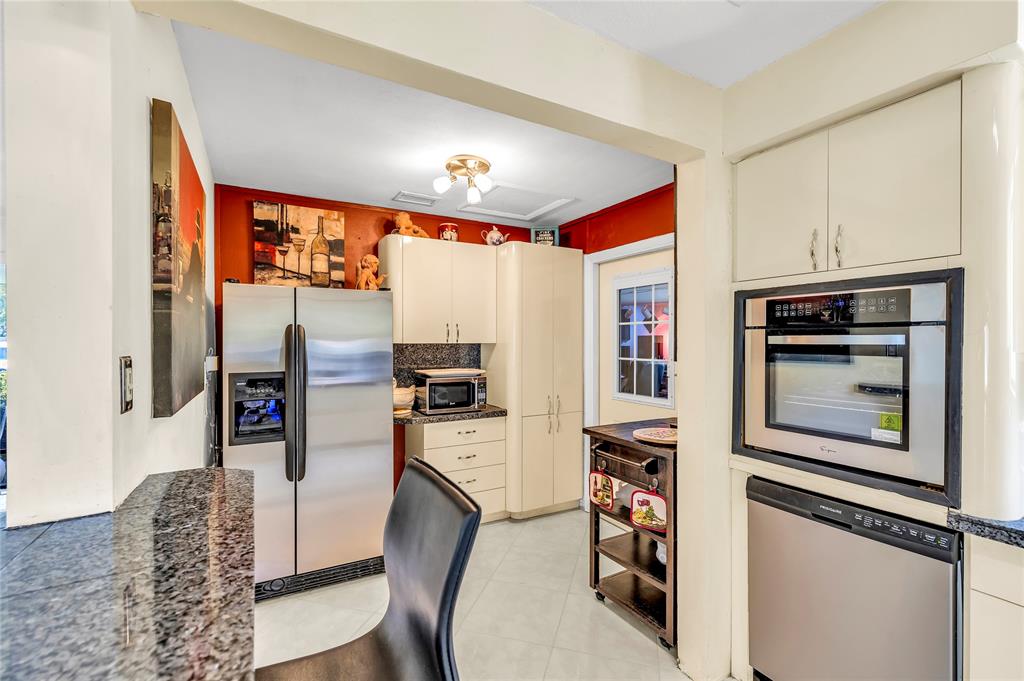 1961 Northeast 31st Street Lighthouse Point, FL 33064 - Photo 19 of 31 a living room with stainless steel appliances furniture and a flat screen tv