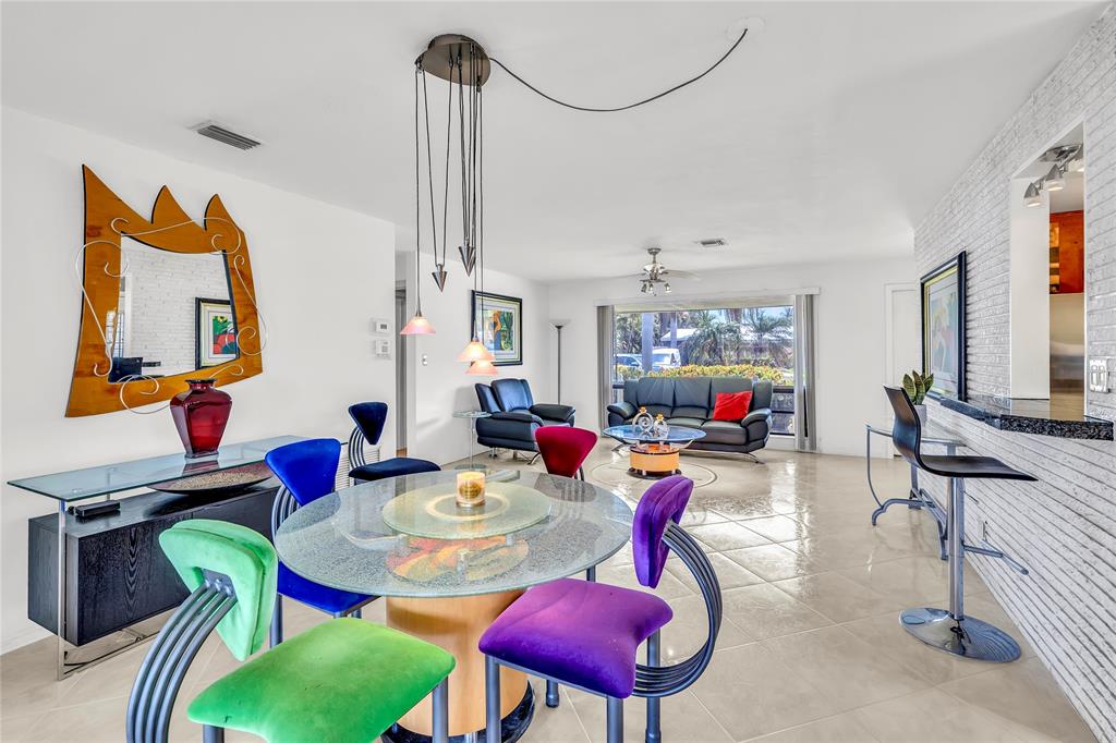 1961 Northeast 31st Street Lighthouse Point, FL 33064 - Photo 20 of 31 a view of a dining room with furniture a chandelier and a window