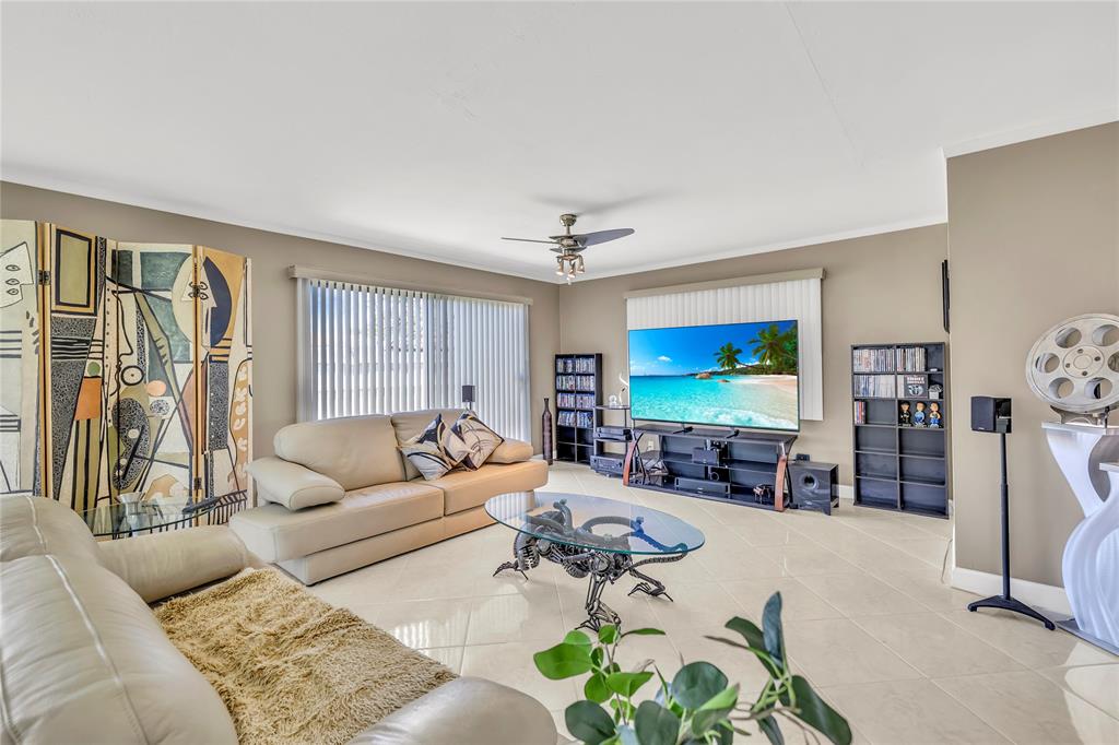 1961 Northeast 31st Street Lighthouse Point, FL 33064 - Photo 23 of 31 a living room with furniture and a flat screen tv