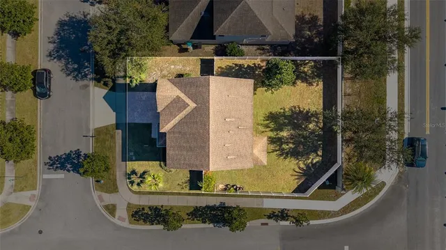 an aerial view of a house with yard swimming pool and outdoor seating