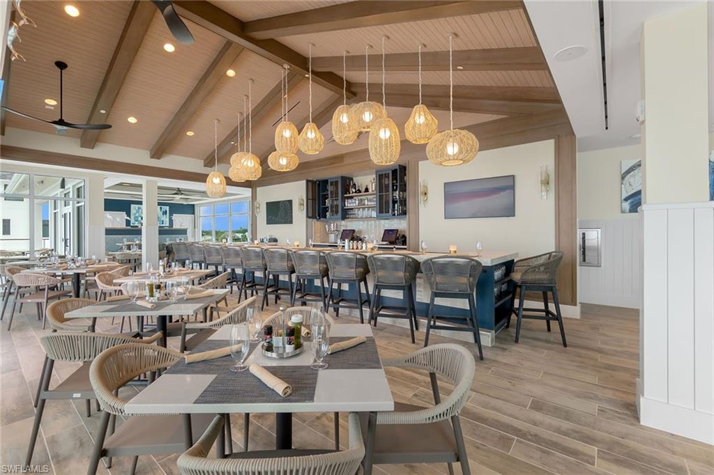 5100 Baybridge Boulevard, Unit 1503 Estero, FL 33928 - Photo 17 of 31 a view of a dining room with furniture window and wooden floor