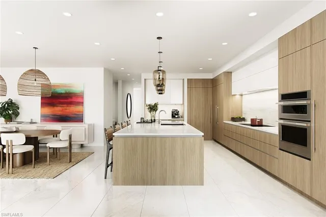 a large kitchen with stainless steel appliances kitchen island granite countertop a sink and a stove