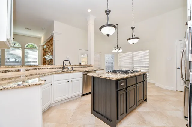 a view of an empty room with wooden floor fireplace and a window